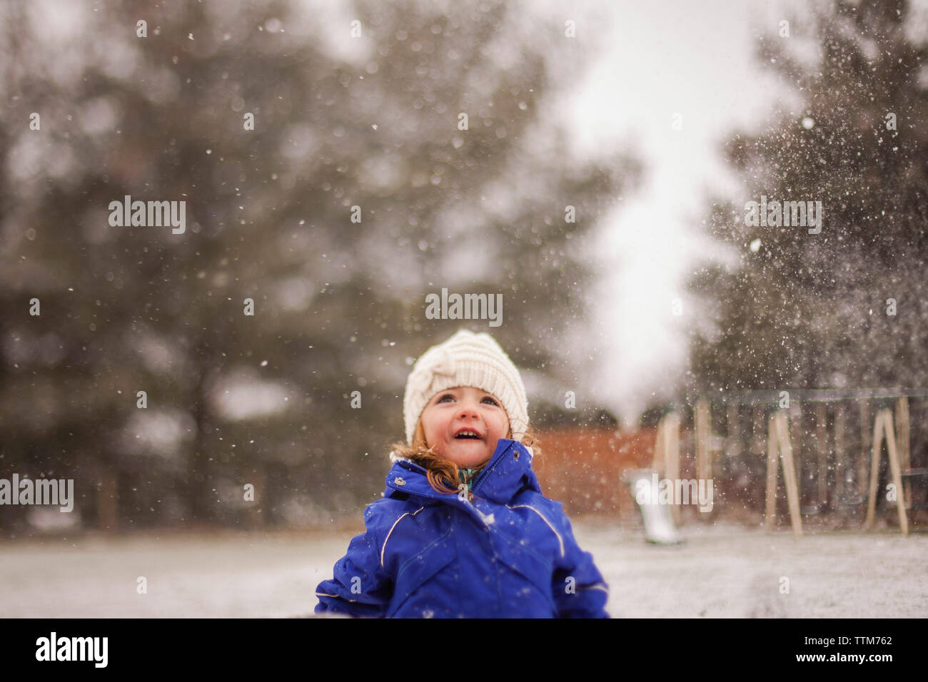 Happy girl enjoying snowfall Stock Photo