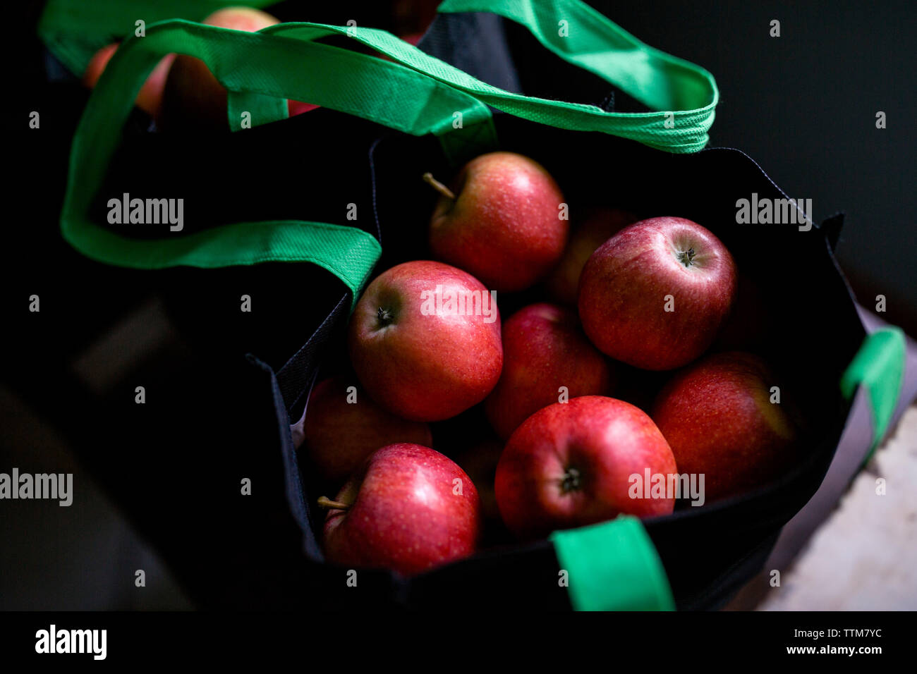 Close-up of fresh ripe apples in bag at home Stock Photo