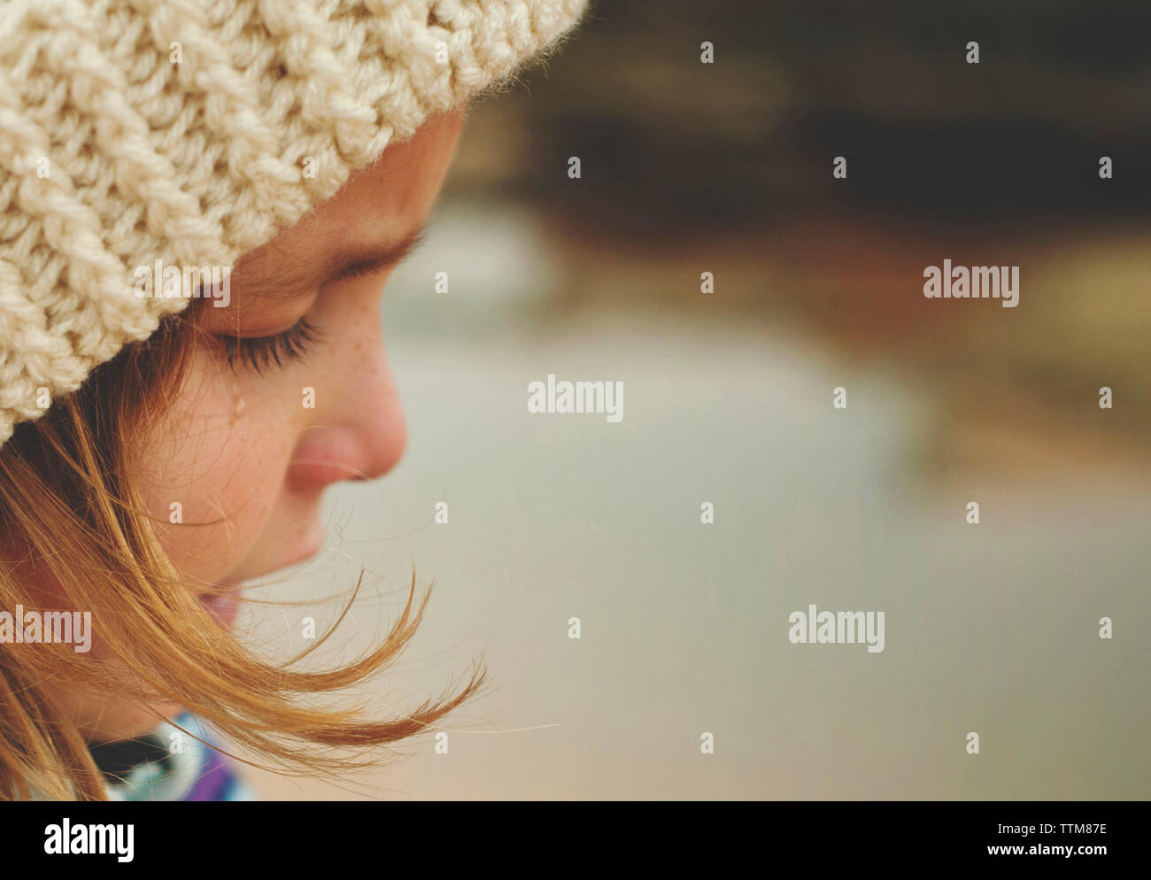 Close-up of sad girl wearing knit hat while crying Stock Photo