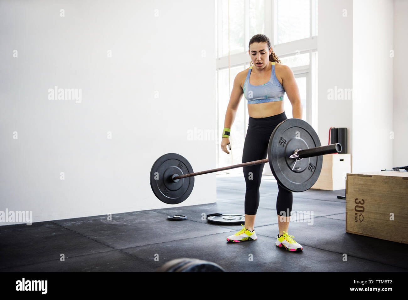 Female athlete throwing barbell in crossfit gym Stock Photo Alamy