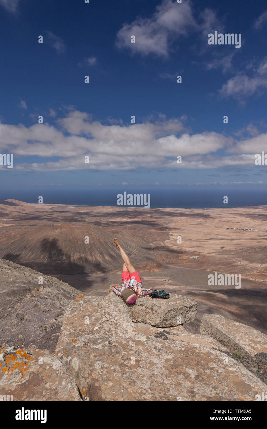20 30 yrs old girl relaxing on summit of a mountain in Fuerteventura Stock Photo