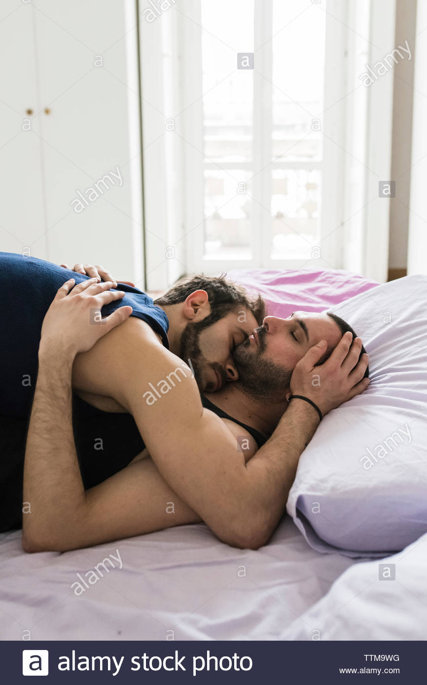Romantic Gay Couple Sleeping On Bed At Home Stock Photo