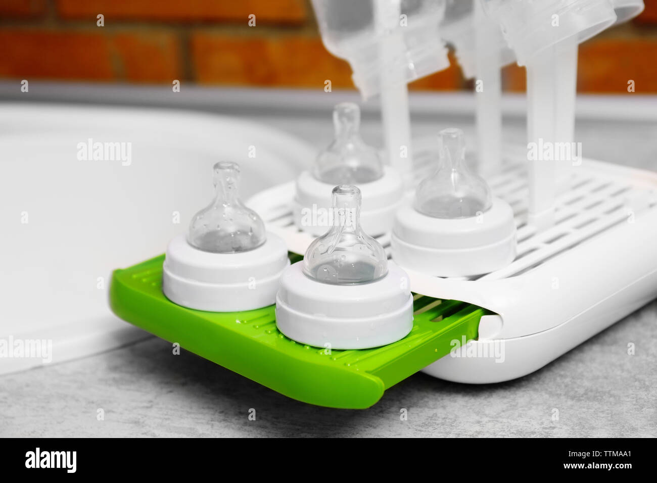 Baby bottles on plastic drying rack Stock Photo Alamy