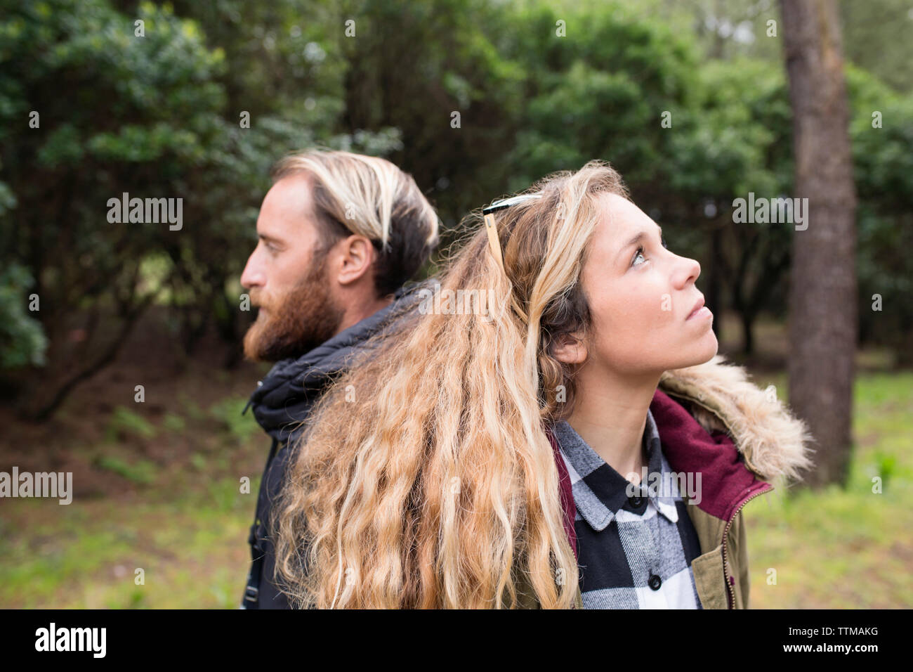 Thoughtful couple in forest Stock Photo