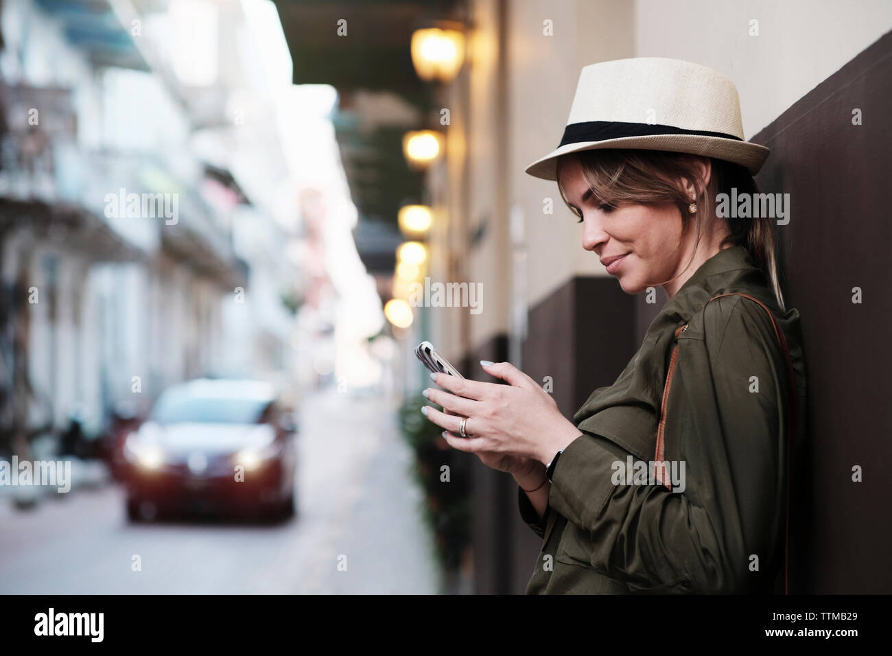 Young Woman Vacationing in Panama waits for Uber car in Casco Antiguo Stock Photo