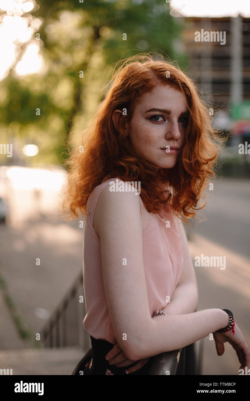 Portrait of young redheaded woman with freckles Stock Photo