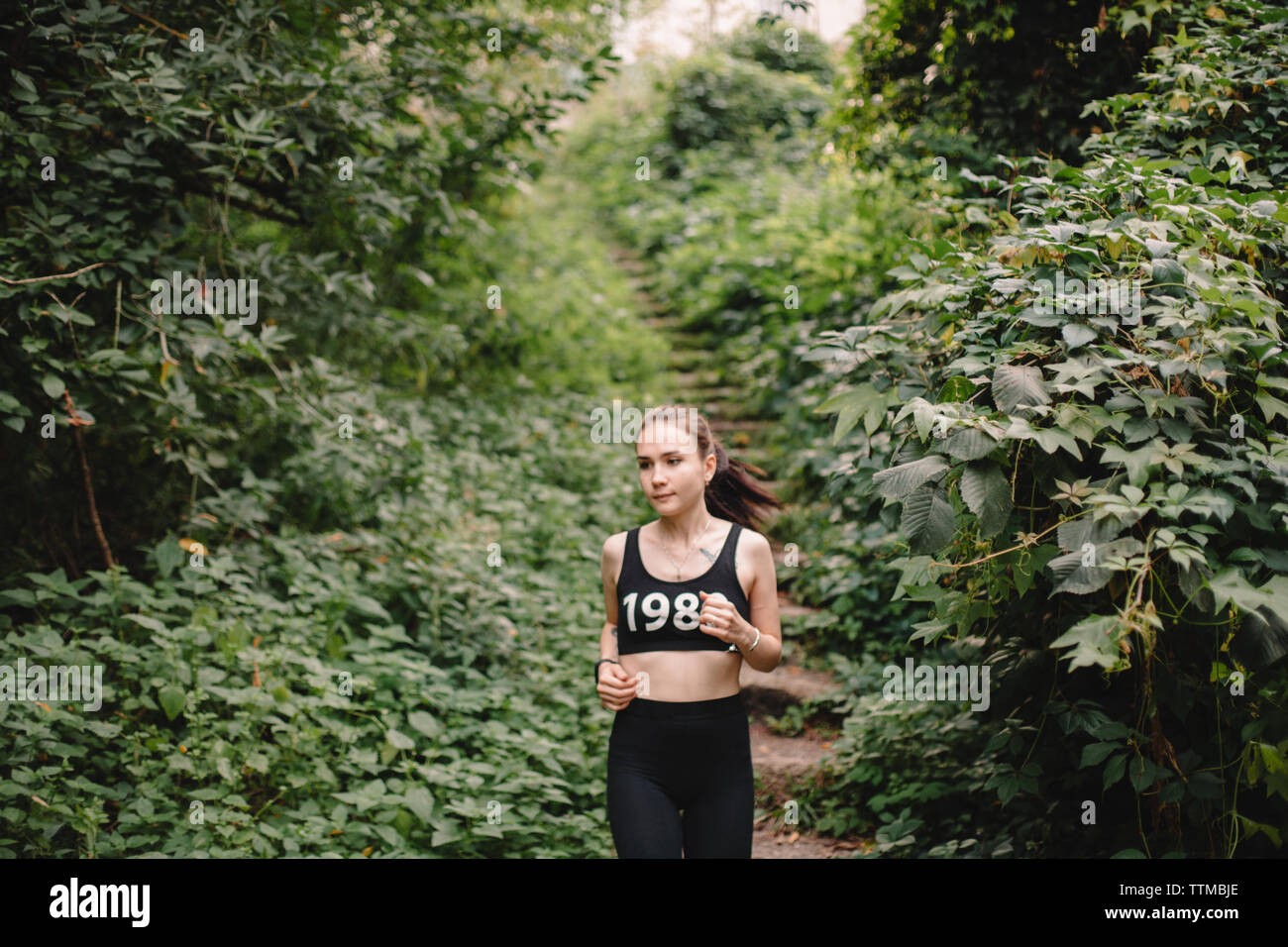 Young woman jogging in park Stock Photo