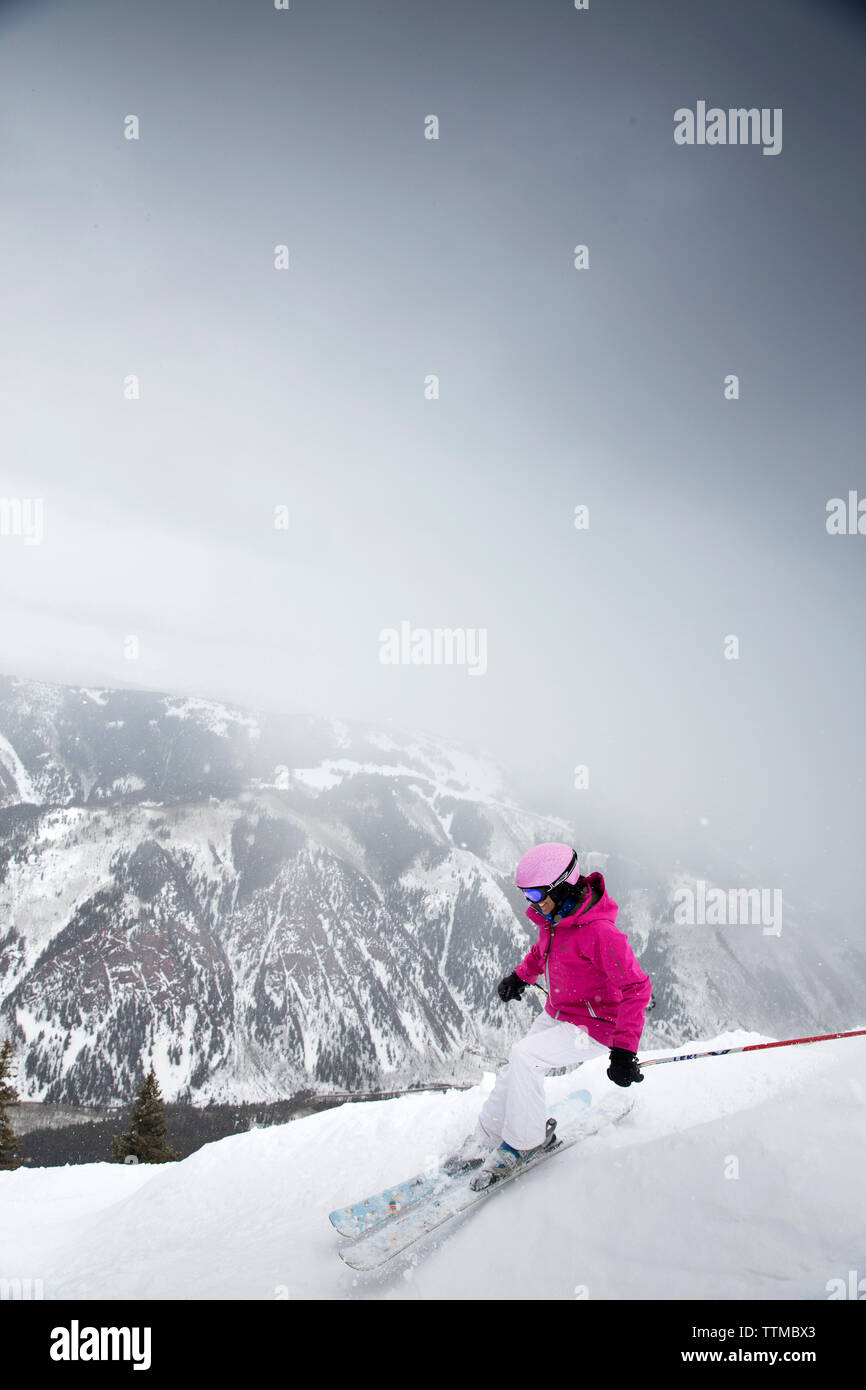 USA, Colorado, Aspen, a woman skiis and makes turns at the top of Kessler's run, Aspen Highlands Ski Resort Stock Photo