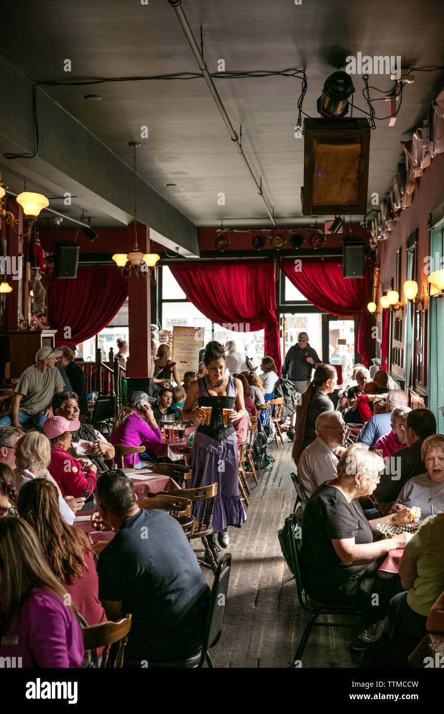 USA, Alaska, Sitka, guests take a break from walking around the streets of downtown Sitka to eat lunch at the Red Onion Saloon Stock Photo