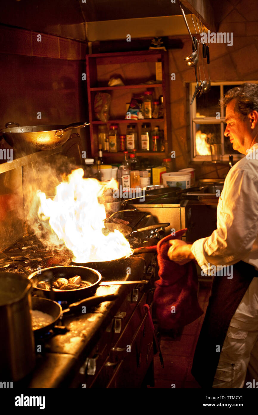 BELIZE, Hopkins, Chef Rob prepares an entree at his restaurant, Chef Rob's Gourmet Cafe Stock Photo