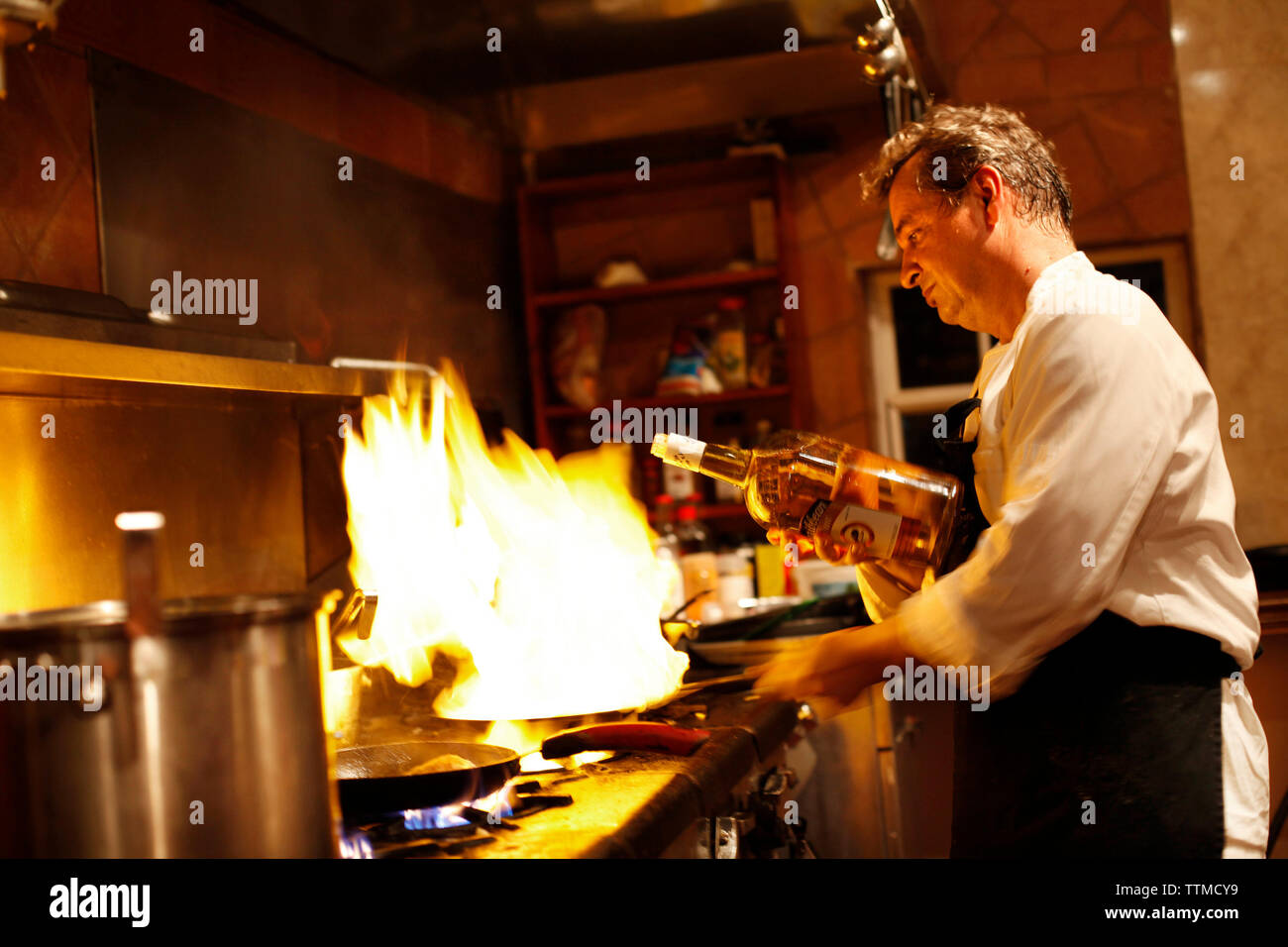 BELIZE, Hopkins, Chef Rob prepares an entree at his restaurant, Chef Rob's Gourmet Cafe Stock Photo