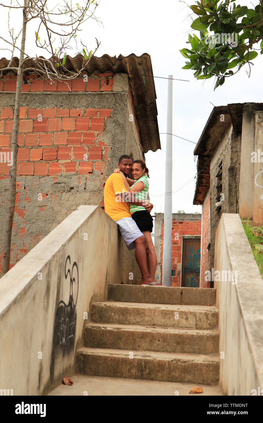 BRAZIL, Rio de Janiero, Favela, a couple resting at the top of the stairs in Complexo do Alemao, a neighborhood within the North Zone Stock Photo