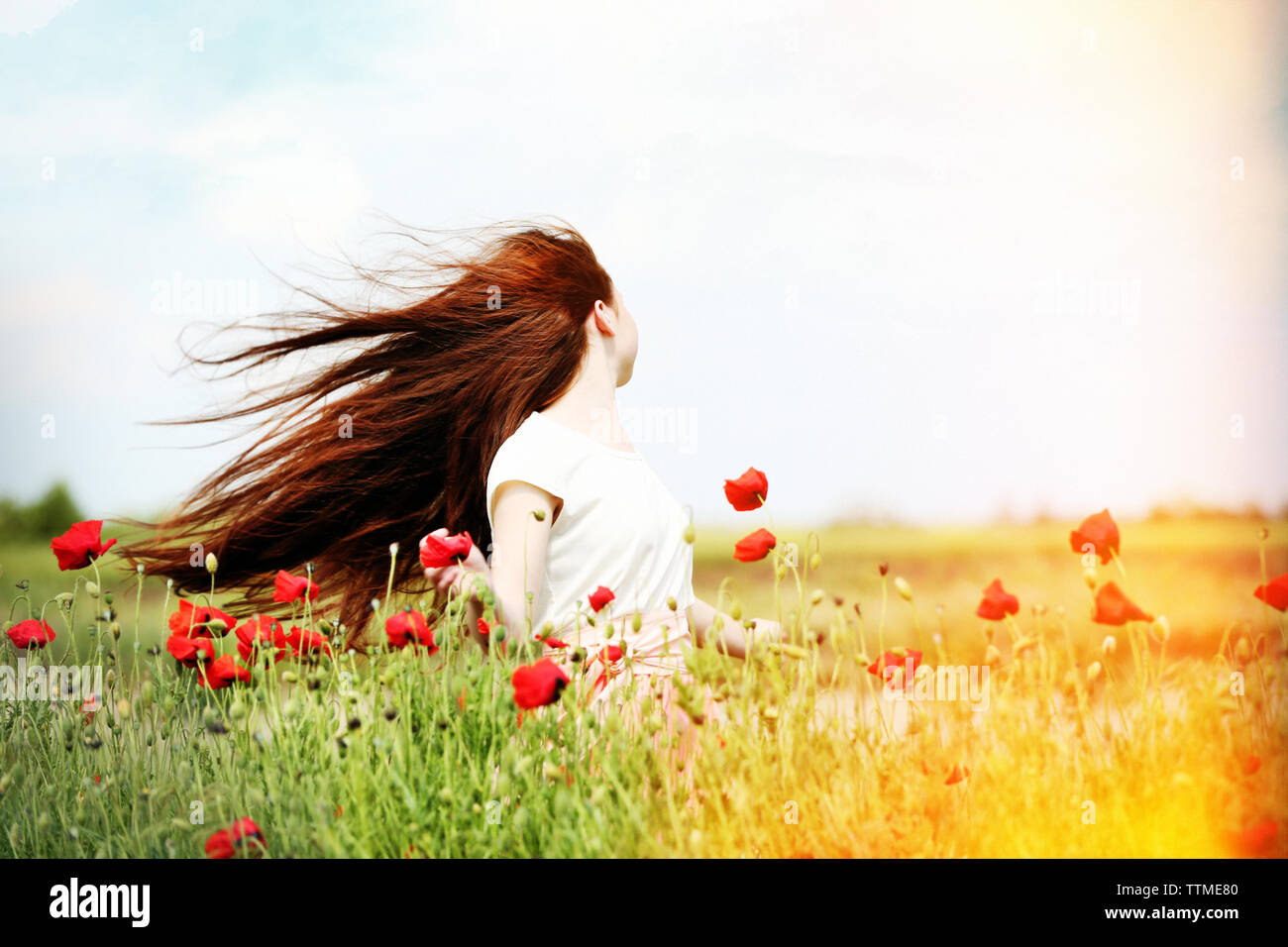 Beautiful girl in poppy field Stock Photo - Alamy