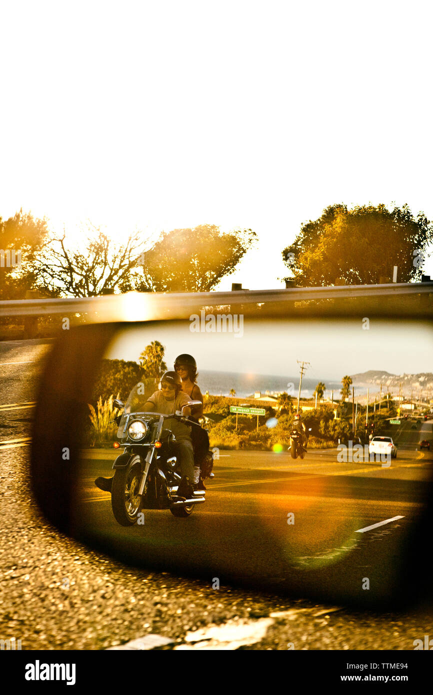 USA, California, Malibu, a couple on a motorcycle cruises along the Pacific Coast Highway at the