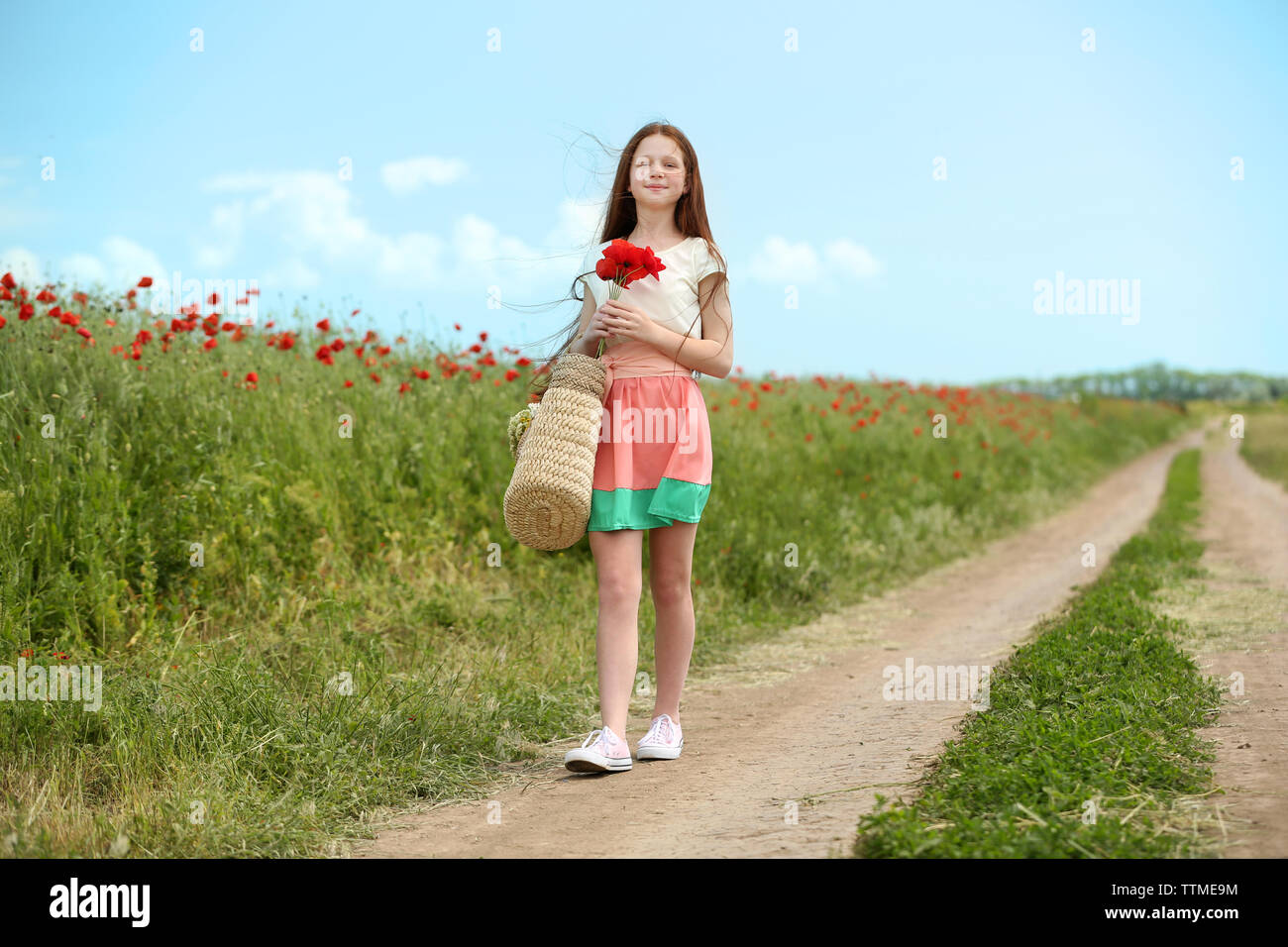 Beautiful girl in poppy field Stock Photo - Alamy