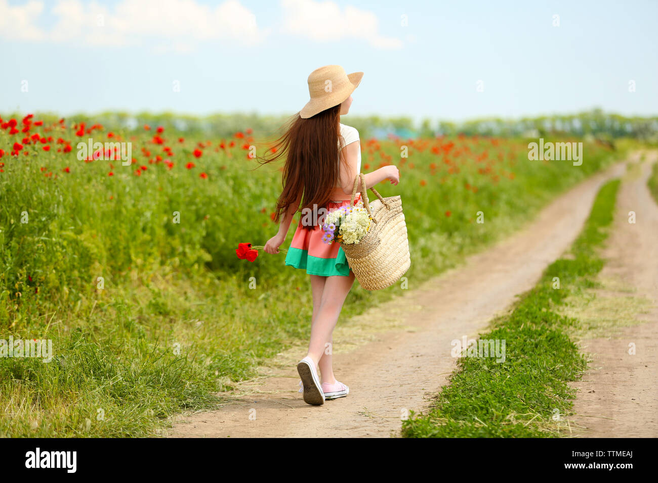 Beautiful girl in poppy field Stock Photo - Alamy