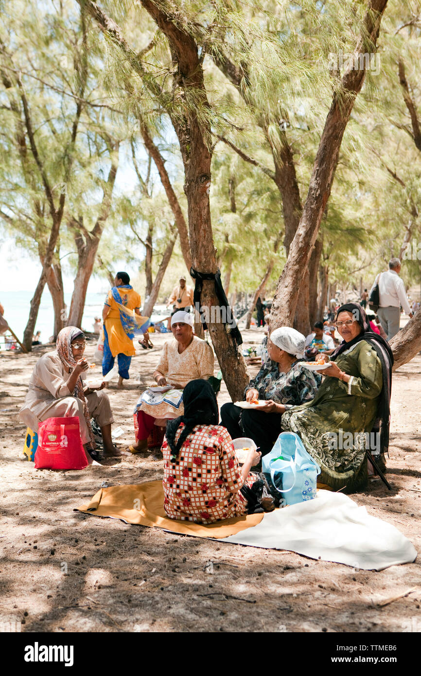MAURITIUS, Muslim friends are having a picnic on the beach at Ile Aux Cerfs Island Stock Photo