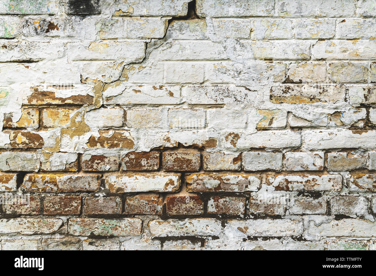 Old brick wall background, distressed messy grunge exterior facade