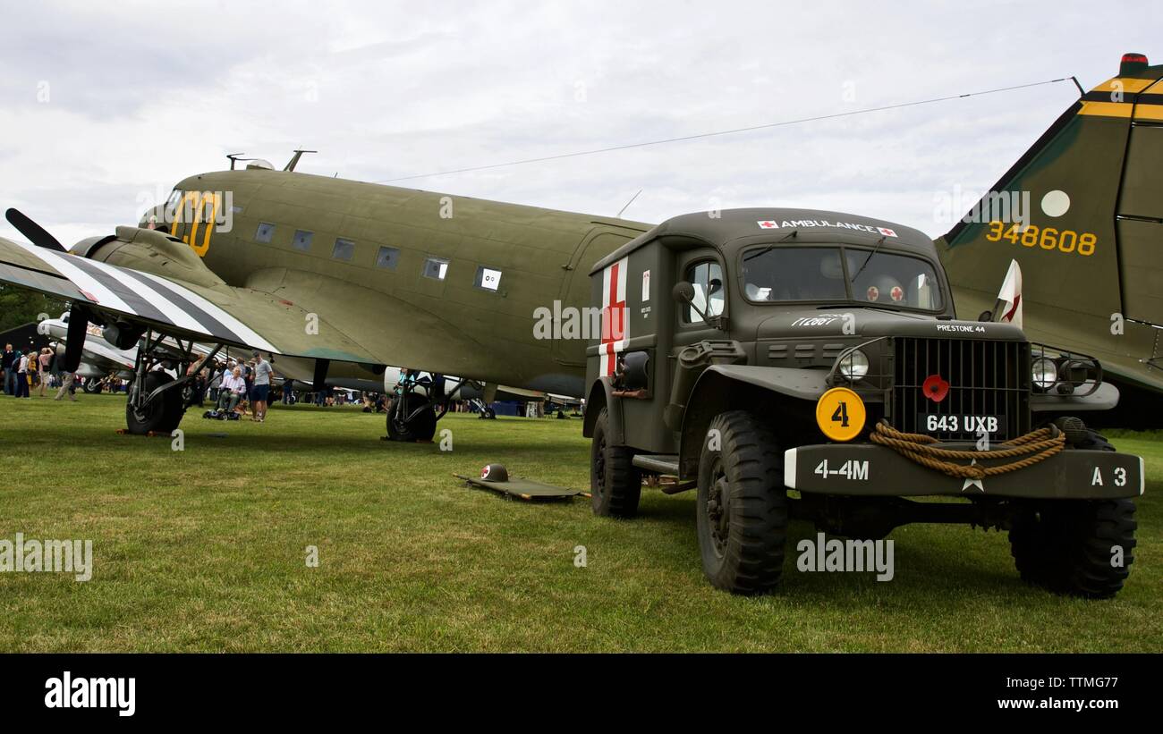 1942 Dodge WC54 Ambulance parked next to a 1944 C-47 Dakota “Betsy's Biscuit Bomber” at Shuttleworth to commemorate the 75th anniversary of D-Day. Stock Photo