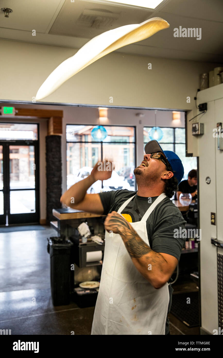 USA, Oregon, Bend, Pacific Pizza and Brew, chef tossing dough Stock Photo