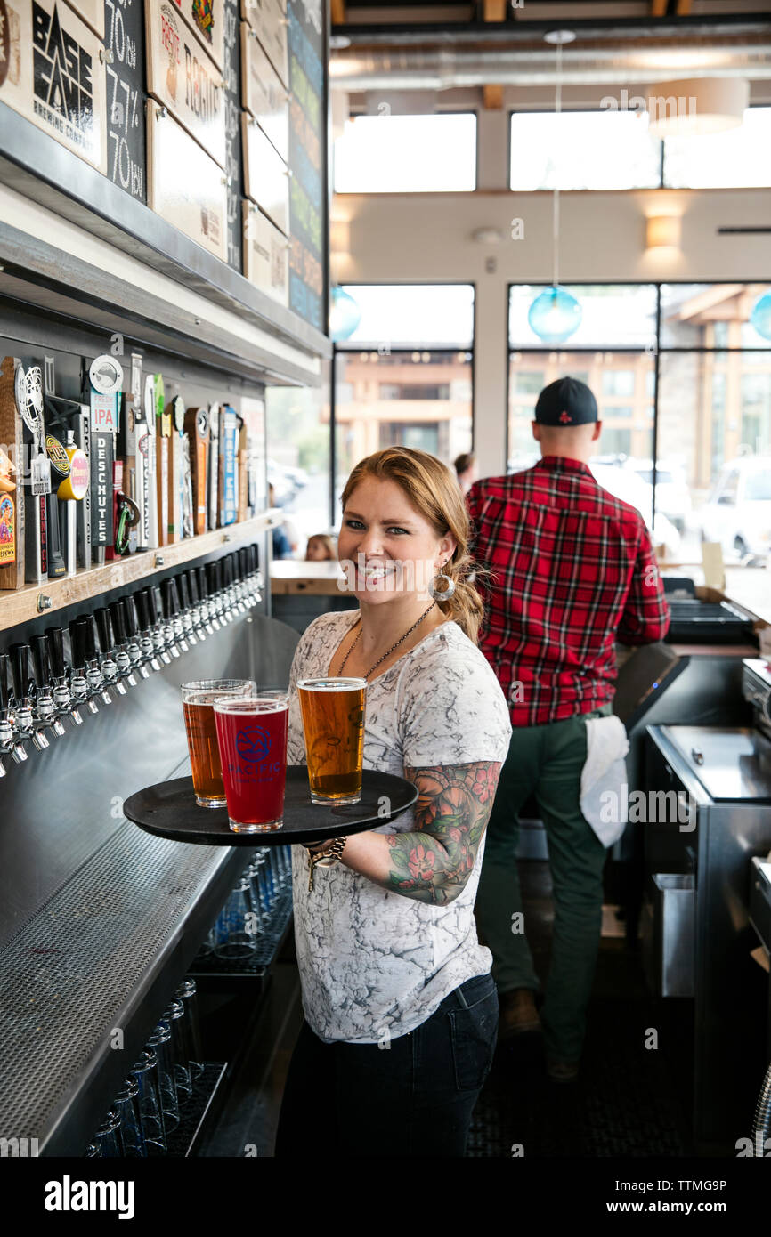 USA, Oregon, Bend, Pacific Pizza and Brew, server bartender pints beer Stock Photo