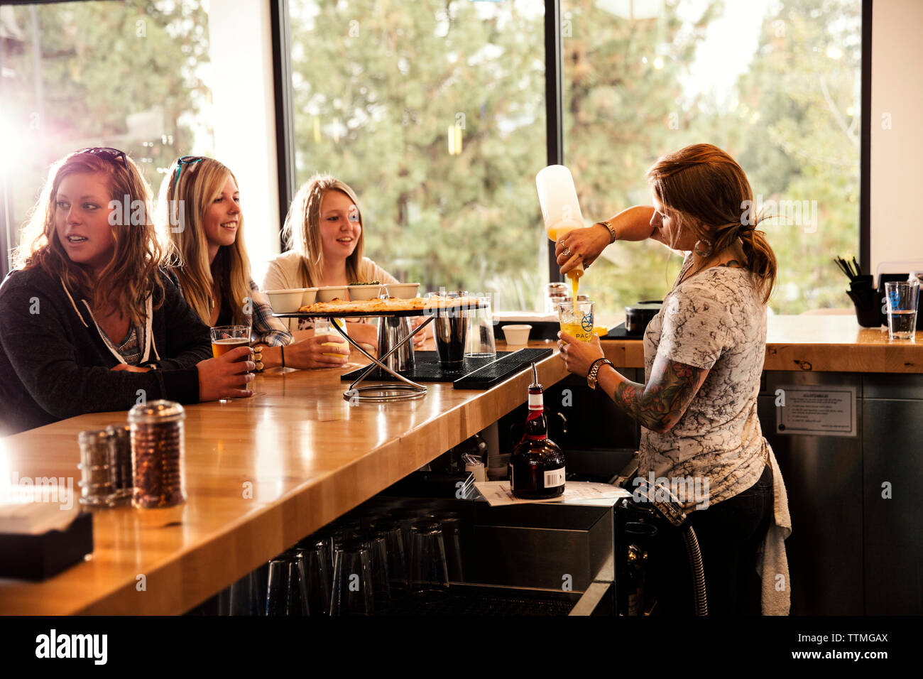 USA, Oregon, Bend, Pacific Pizza and Brew, people at bar & bartender Stock Photo