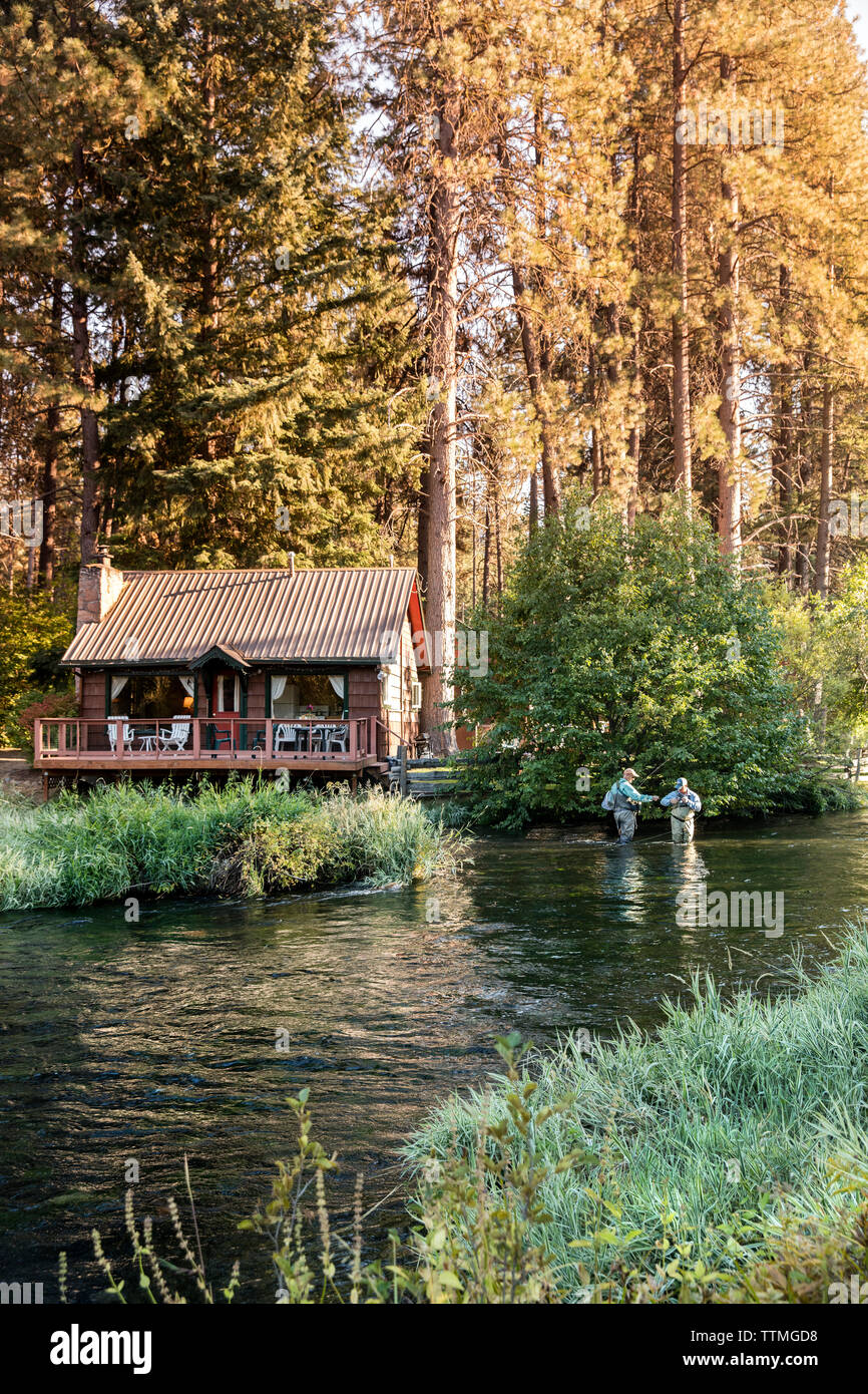 USA, Oregon, Camp Sherman, Metolius River Resort, Flyfishermen on the Metolius looking away from resort Stock Photo