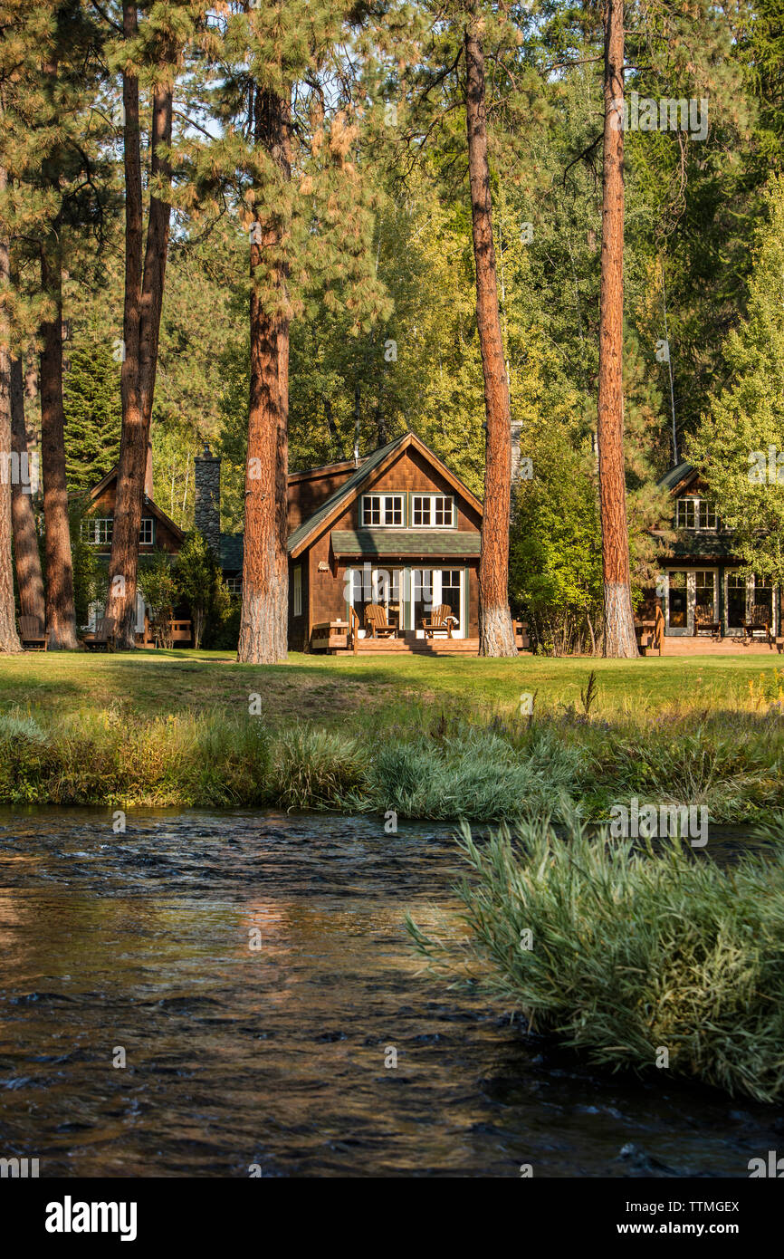 USA, Oregon, Camp Sherman, Metolius River Resort, view of cabins from river Stock Photo