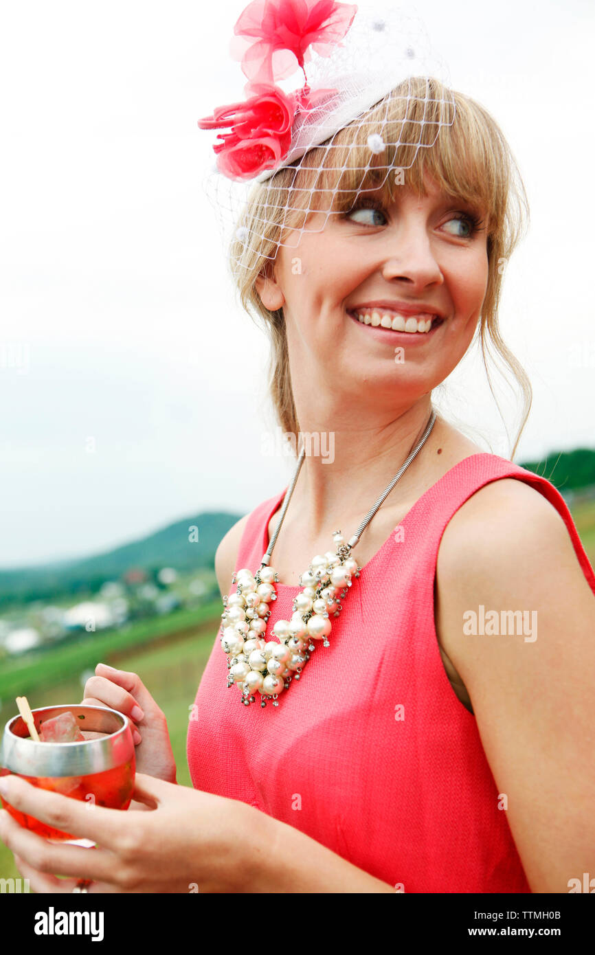 USA, Tennessee, Nashville, Iroquois Steeplechase, woman drinking Moonshine Cherry-Basil Blush Stock Photo
