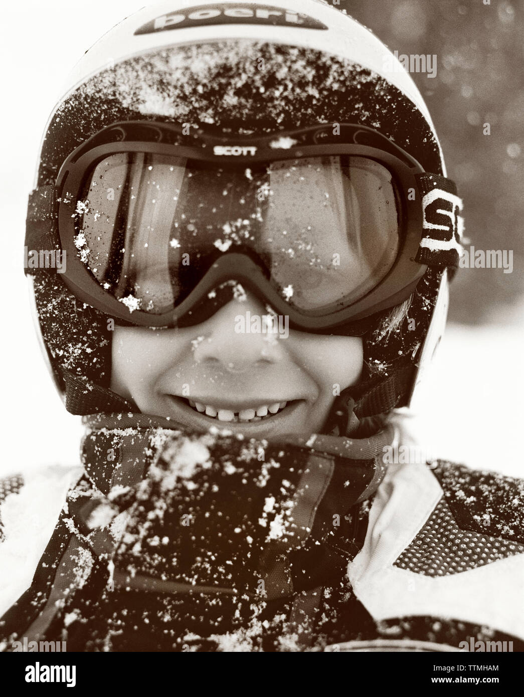 USA, Utah. boy wearing ski goggles with a face full of snow, Alta Ski Resort (B&W) Stock Photo