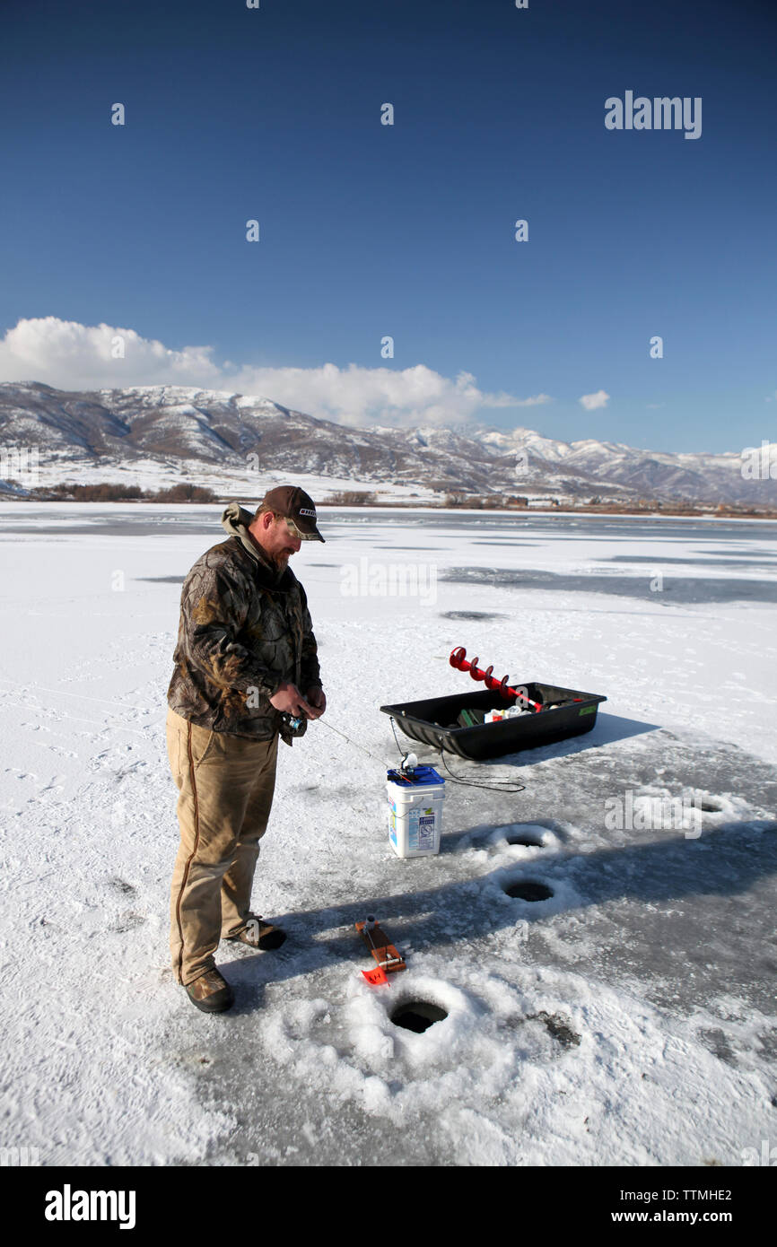 USA, Utah, Midway, Garrett ice fishing at Deer Creek Reservoir