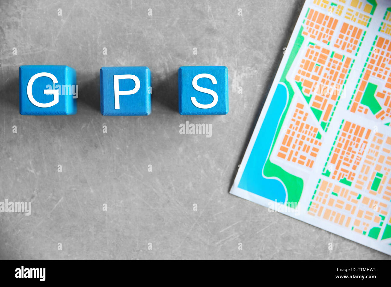 Cubes with word GPS and map on grey background, top view Stock Photo