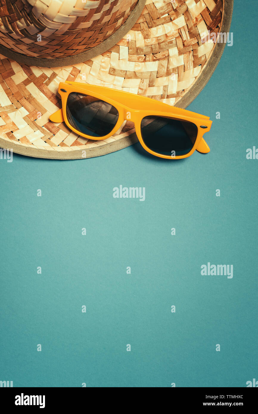 Straw hat and sunglasses in summer holiday concept, top view flat lay ...