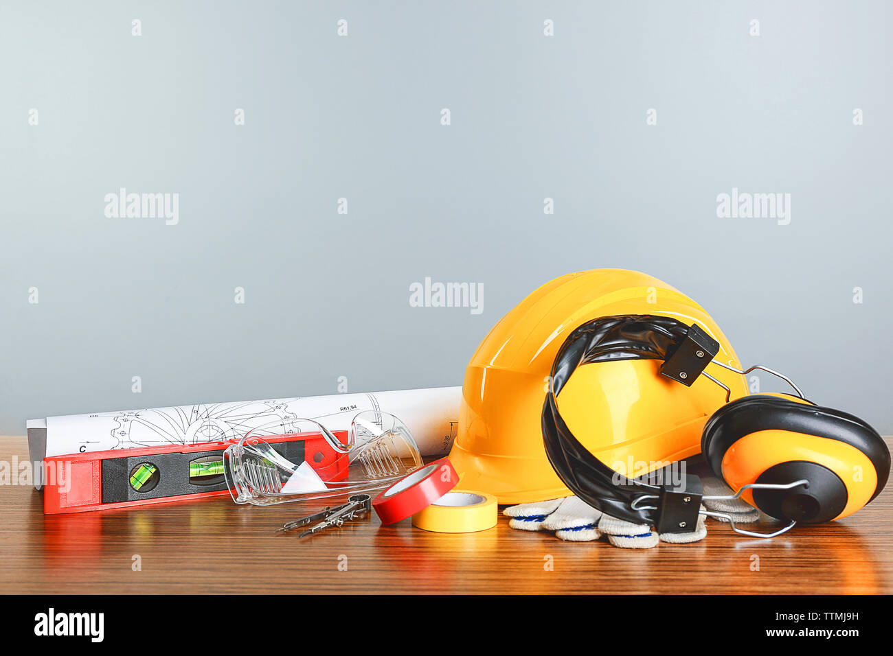 Construction blueprints with tools and helmet on light background Stock Photo