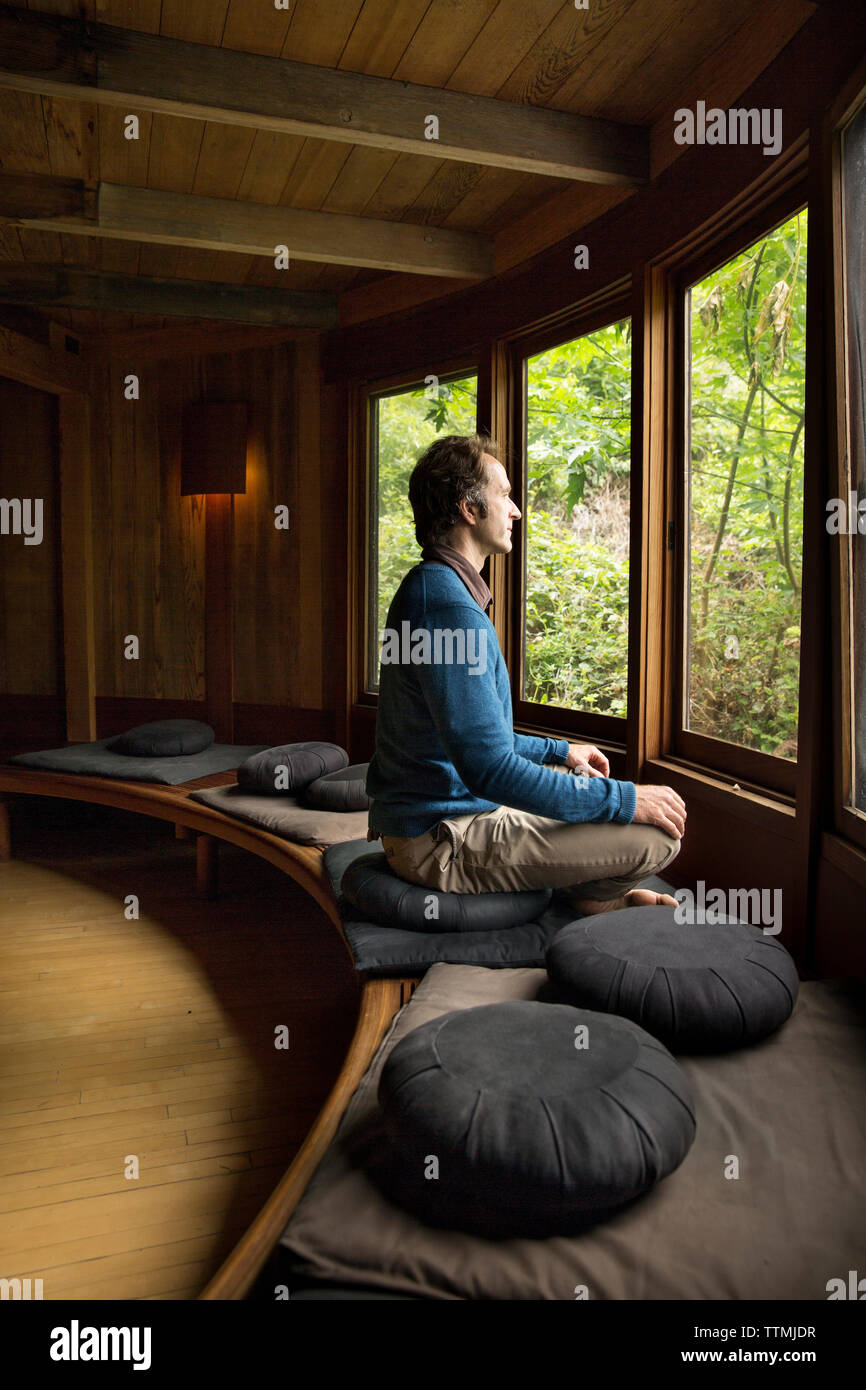 USA, California, Big Sur, Esalen, a man sits and performs a sitting meditation in the Meditation Center at the Esalen Institute Stock Photo