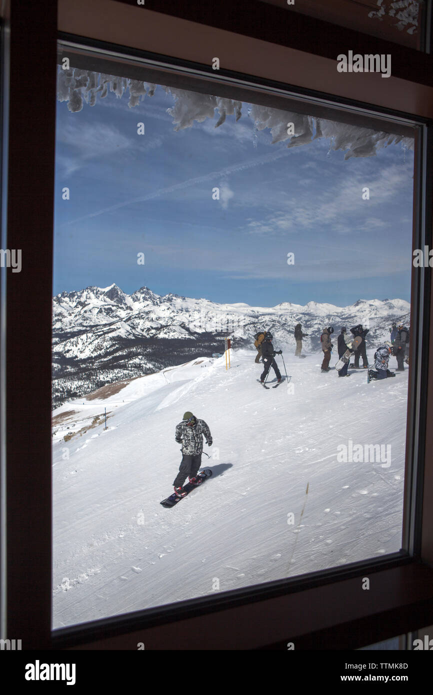 USA, California, Mammoth, a view of several skiers and snowboarders as the depart down the run at Mammoth Ski Resort Stock Photo