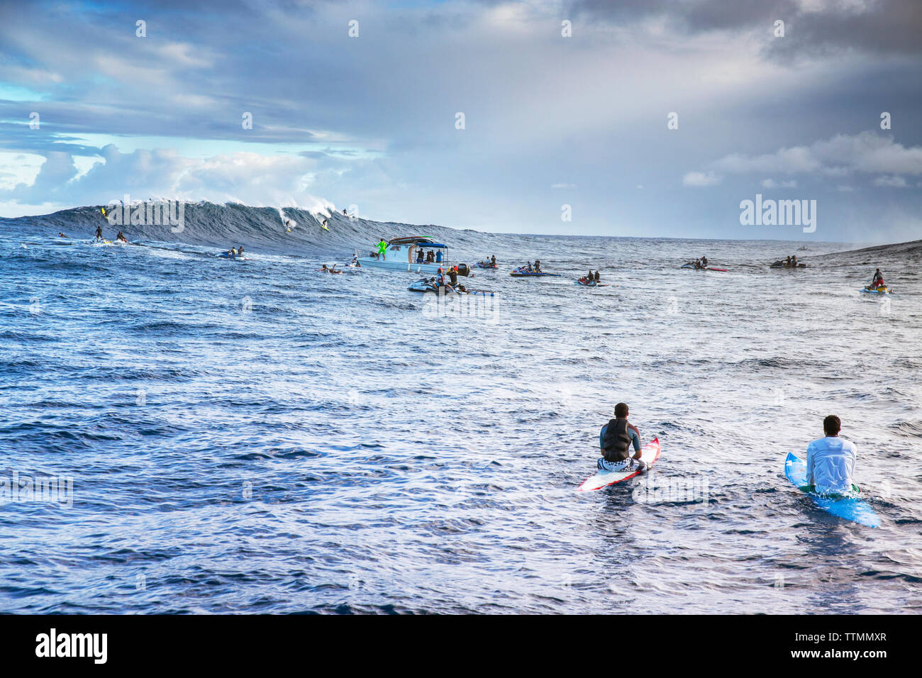 USA, HAWAII, Maui, Jaws, surfers and boats in the water at Peahi on the