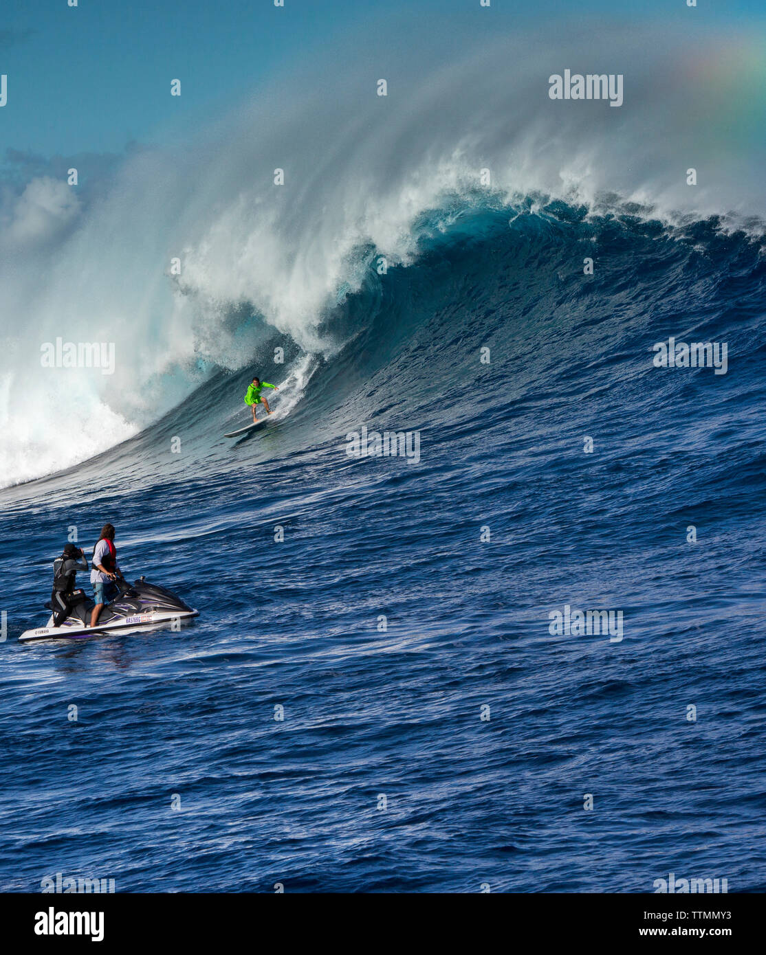 USA, HAWAII, Maui, Jaws, big wave surfers taking off on a wave at Peahi