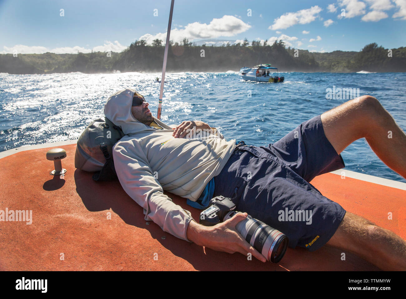 USA, HAWAII, Maui, Jaws, big wave surfer Kohl Christensen resting on