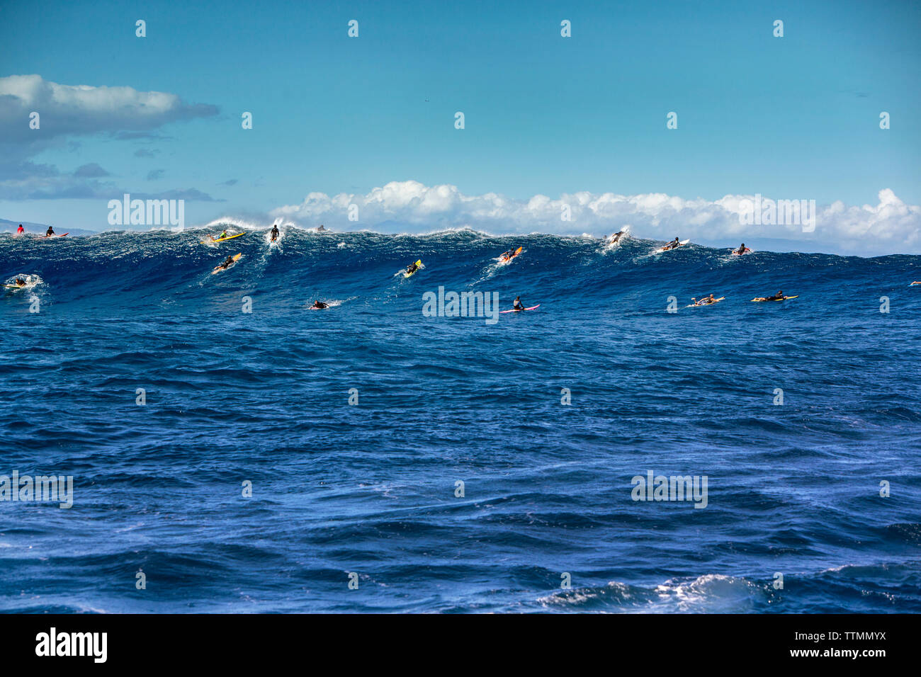 USA, HAWAII, Maui, Jaws, big wave surfers taking off on a wave at Peahi on the Northshore Stock Photo