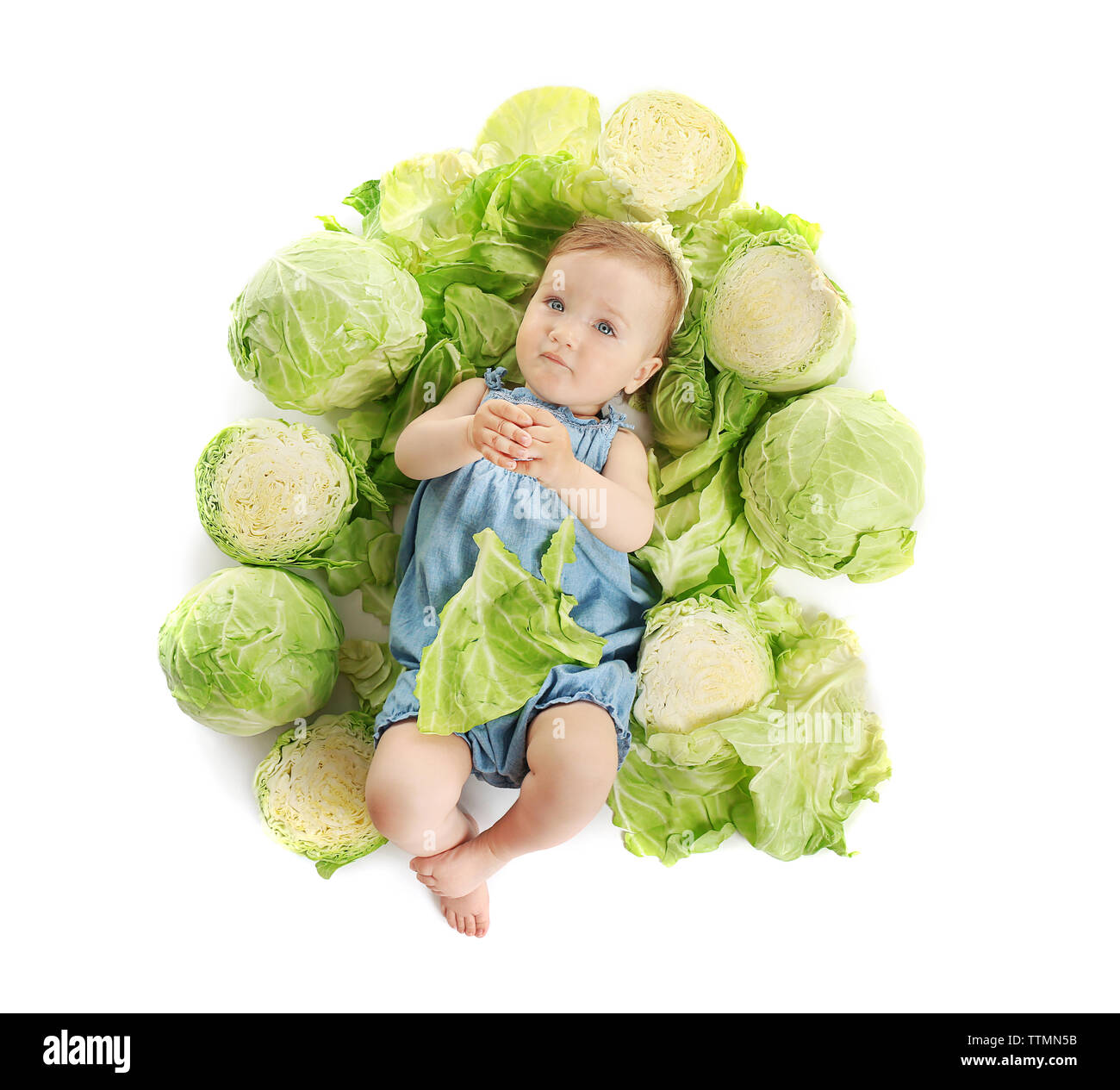 Cute baby girl in cabbage, isolated on white Stock Photo Alamy