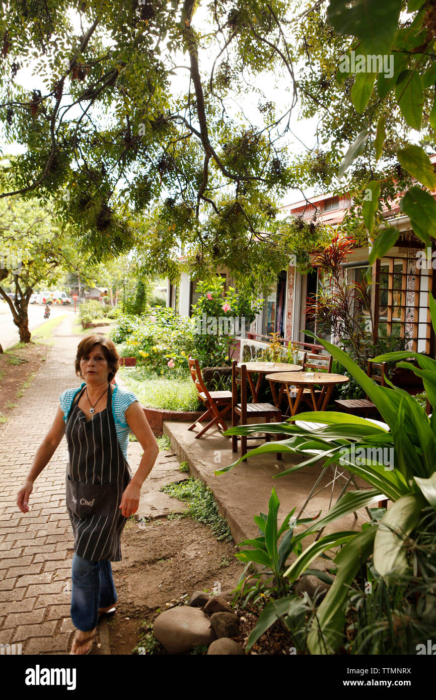 easter ISLAND, CHILE, Isla de Pascua, Rapa Nui, a woman in front of her restaurant in Hanga Roa Stock Photo