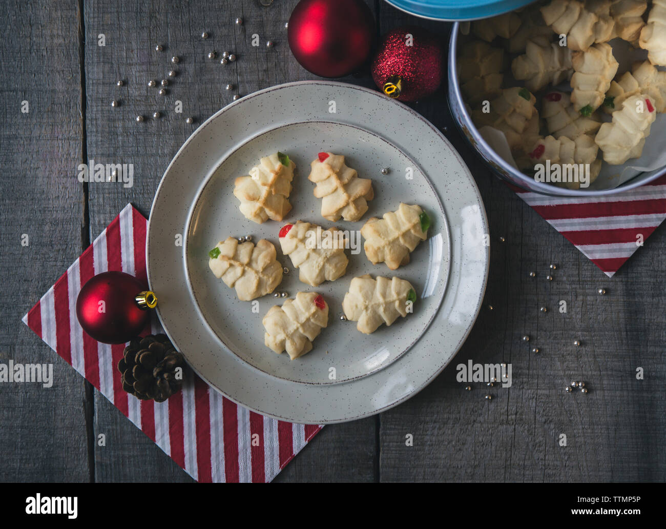Overhead view of fresh cookies with decorations on wooden table during christmas Stock Photo