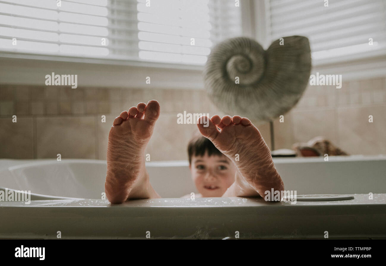 Portrait of boy taking bath in bathtub Stock Photo Alamy