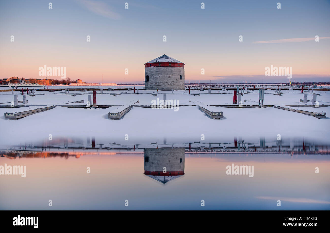 Tower and docks at sunset on waterfront of Kingston in winter. Stock Photo