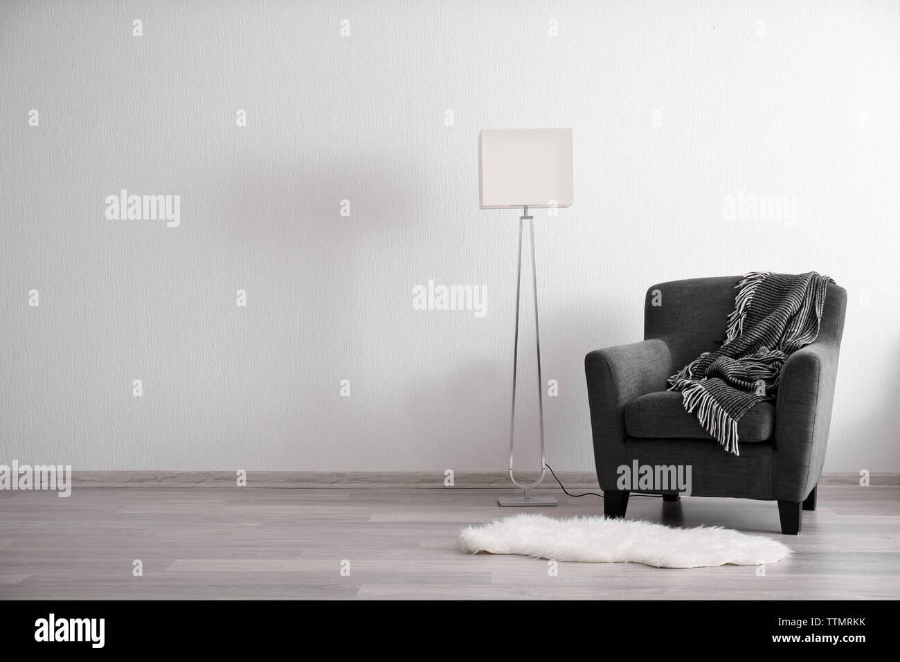 Room interior with lamp and dark armchair Stock Photo - Alamy