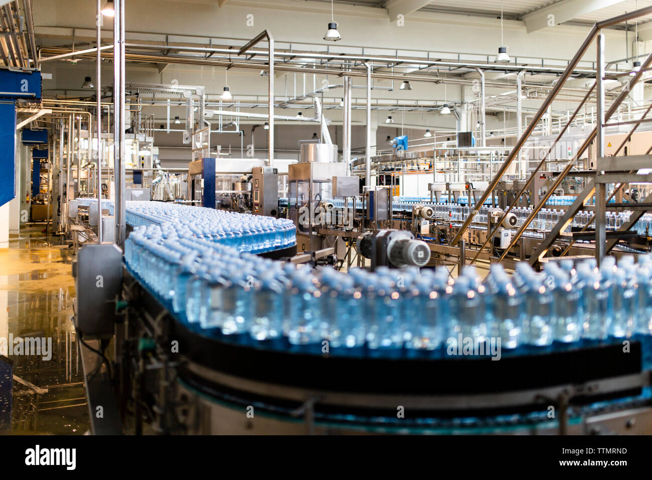 Water bottles on conveyor belt in industry Stock Photo