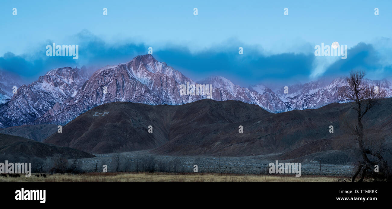 Majestic view of mountain ranges against sky during dusk Stock Photo