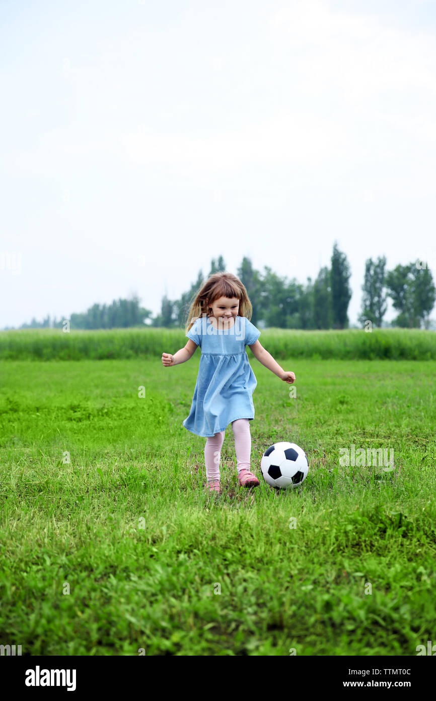 Little girl playing football outdoor Stock Photo - Alamy