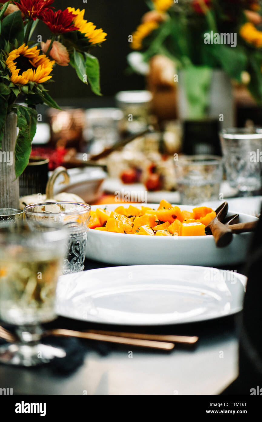 Pumpkin served in plate with wine on table Stock Photo
